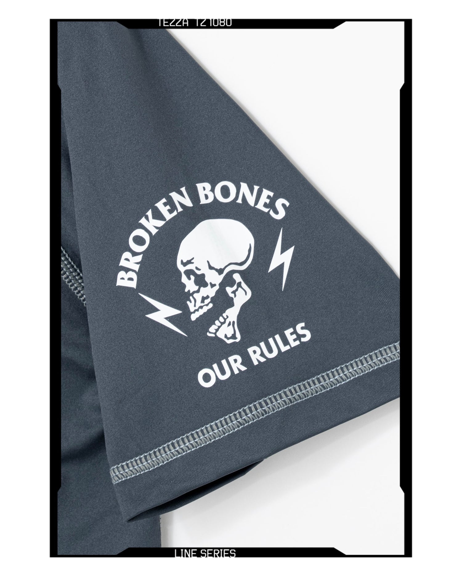 Gray t-shirt with 'Broken Bones, Our Rules' graphic design on a white background